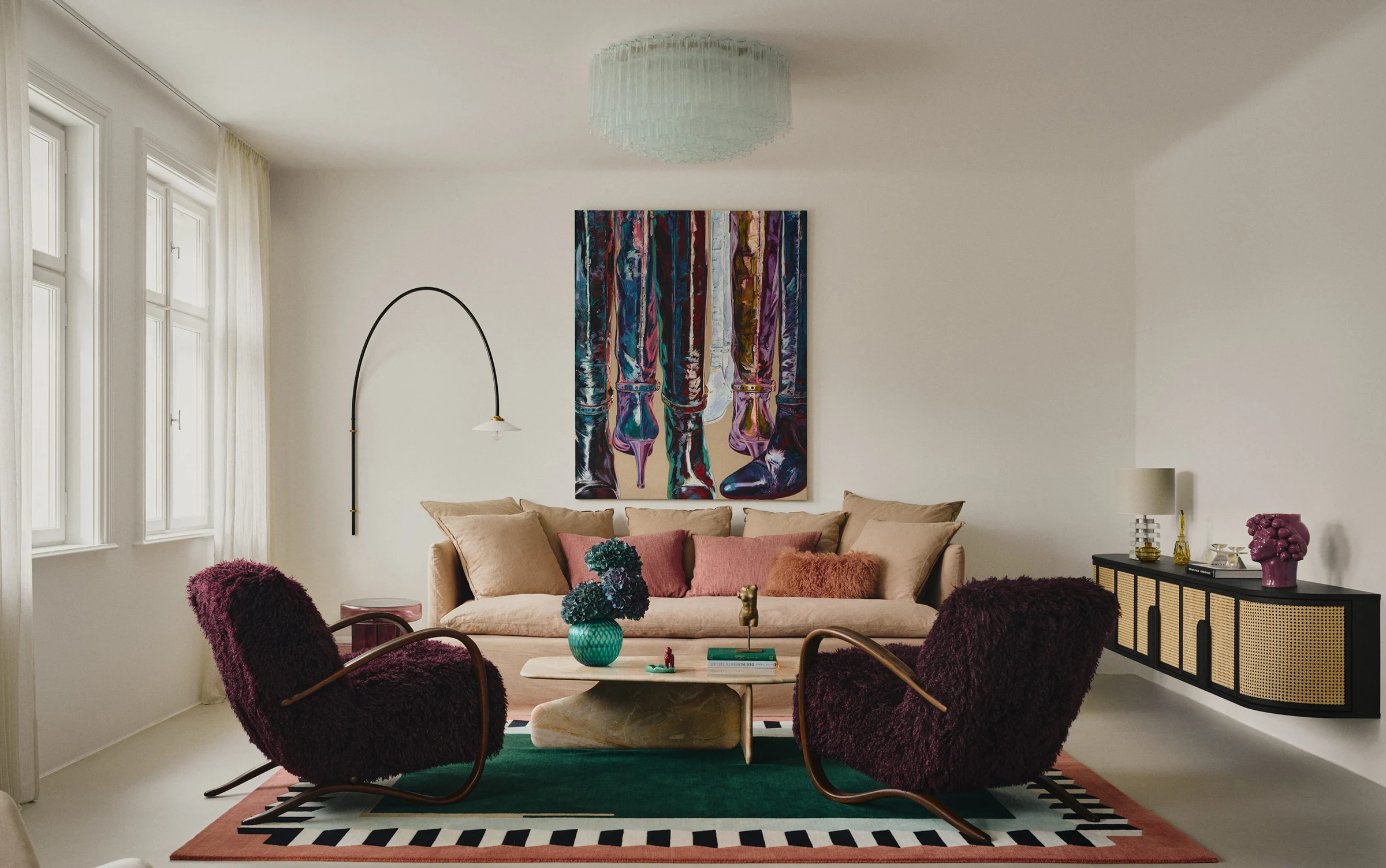 Living room by MHI Martina Hausel Interiors with a linen sofa, two shaggy aubergine armchairs and a large painting of boots. Photo: Tomo Yarmush