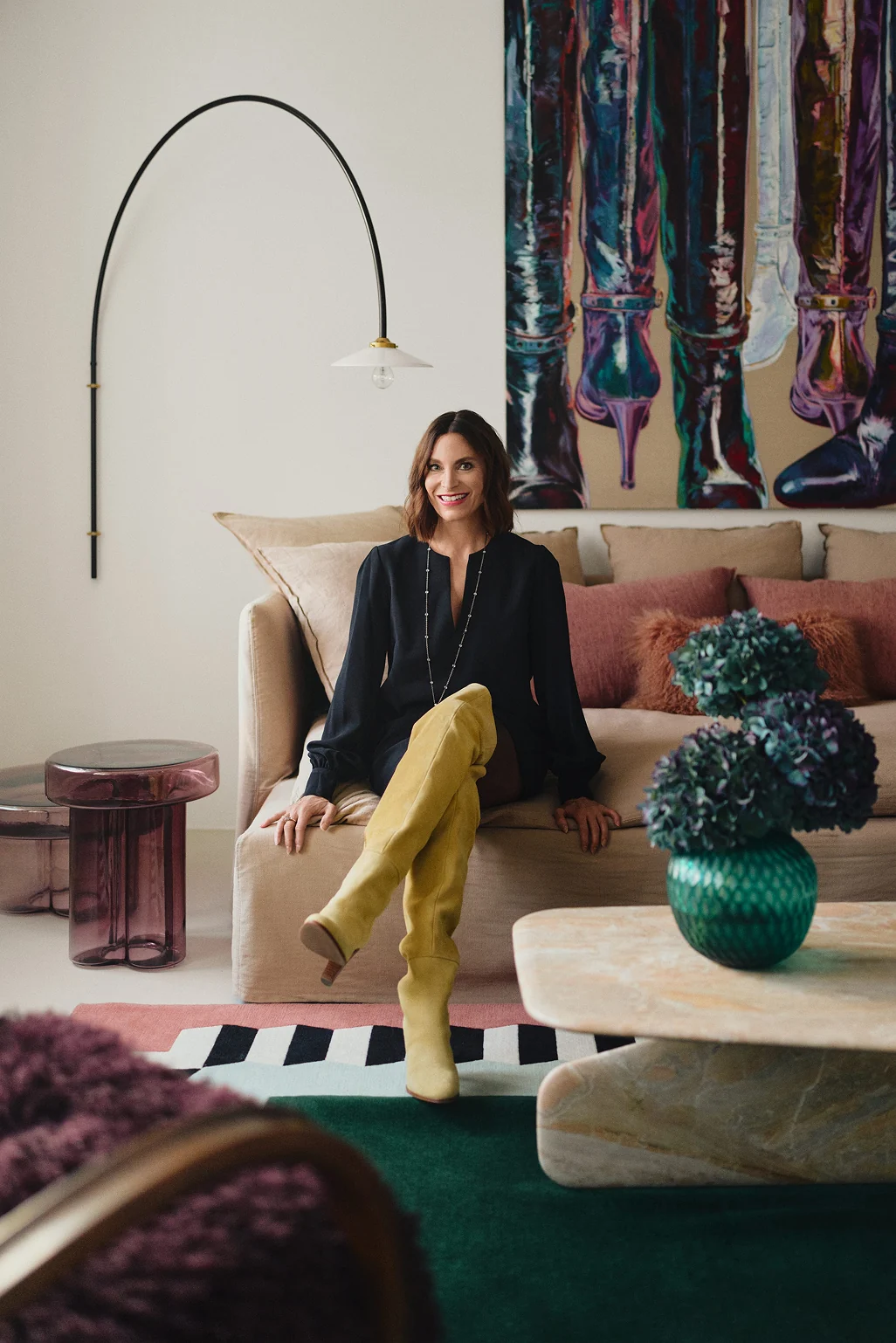 Martina Hausel on a linen sofa in a living room designed by MHI. Photo: Tomo Yarmush
