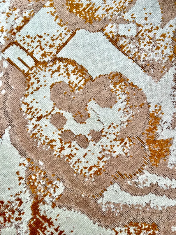 Detail of a jacquard fabric in beige and gold